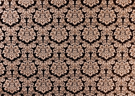 Abstract background of a heavy purple brocade fabric with interwoven repeat design.の写真素材