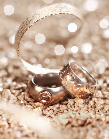 Luxury used Rings with a golden ribbon on a blurry backgroundの写真素材