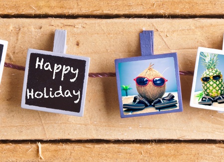 Happy Holiday snaps on a line of cool fruity friends, a coconut and pineapple, enjoying the tropics in their sunglasses and slip slopsの写真素材