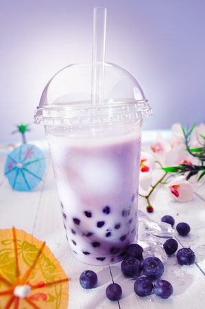 Bubble tea blended with milk and black currant berries and purple boba or pearlsの写真素材