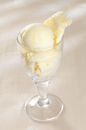 High angle view of a glass filled with delicious creamy vanilla ice-cream on a white backgroundの写真素材