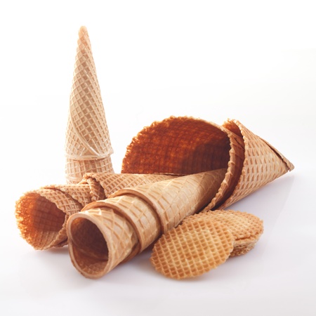 Assortment of icecream cones and cornets in different shapes and sizes together with wafer biscuits on a white backgroundの写真素材