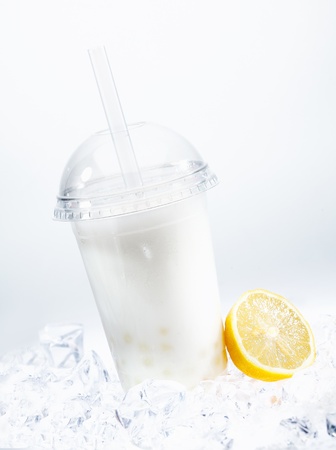 Tangy lemon boba tea with tapioca pearls in a covered glass chilled on iceの写真素材