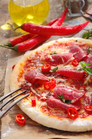 Pizza Salami with peperoni or peppers and olive oil for italian restaurants conceptsの写真素材
