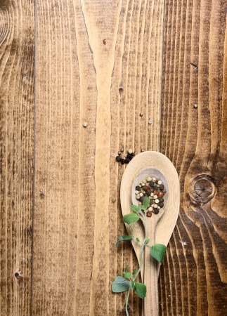 Wooden spoons on table top with peppercornsの写真素材