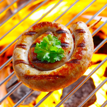 Smoking Flaming Rolled Sausage in a close up shotの写真素材