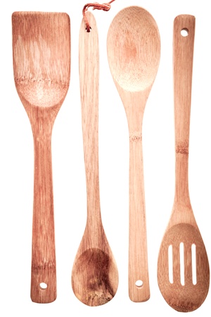 Set of wooden cooking utensils with a spatula, spoon, ladle and draining spoon isolated on a white backgroundの写真素材