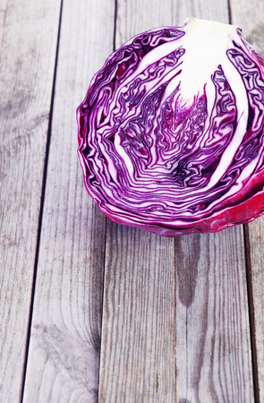 Close up Slice of Healthy Red or Purple Cabbage on Top of Wooden Platform. Emphasizing Copy Space.の写真素材