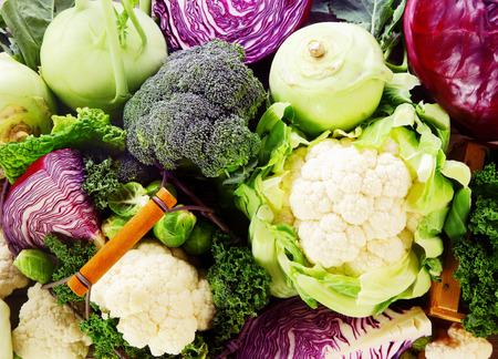 Background of healthy fresh cruciferous vegetables with brioccoli, cabbage, cauliflower, brussels sprouts kale and kohlrabi, close up full frame