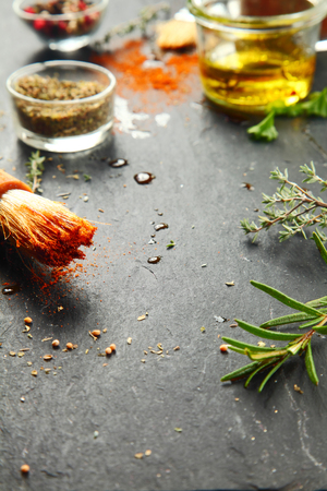 Close up Messy Black Kitchen Table with Fresh Herbs and Spices for Recipe.の写真素材