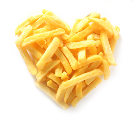 Overhead Still Life of Straight Cut French Fries in Shape of Heart on White Backgroundの写真素材