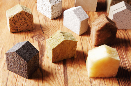 Close up Various Scattered Blocks of insulation Model Hous in Different Standing on Top of the Wooden Table