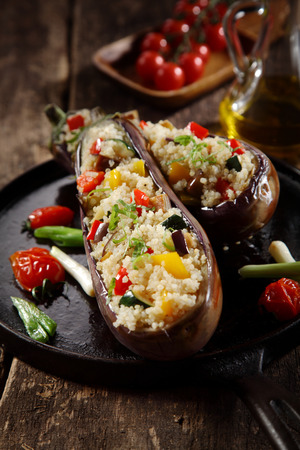 Vegetarian stuffed quinoa aubergine menu on a rustic wooden backgroundの写真素材
