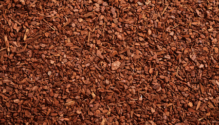 Top down full frame background of brown natural tree bark mulch with copy space for gardening or...
