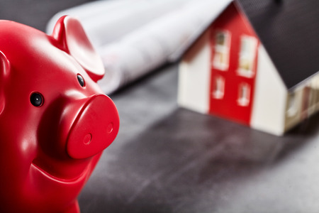 Piggybank in front of the own new house building for architect and finance conceptsの写真素材