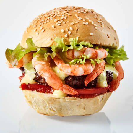 Closeup of delicious scampi burger in sesame see bread bun with saladの写真素材