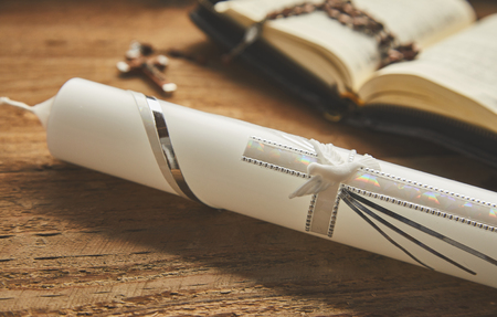 Christian candle on wooden background for holy baptism invitationsの写真素材