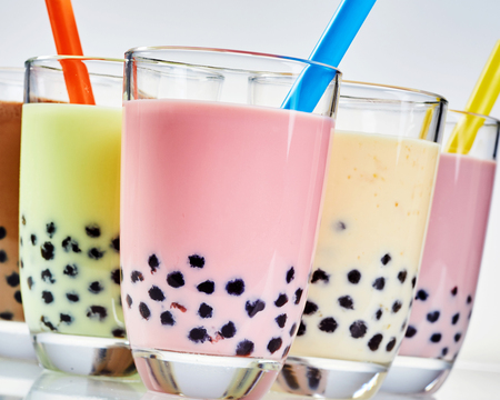 Close up detail of tapioca pearls in bubble tea flavored with fresh fruit and milk and served in glasses with a strawの写真素材