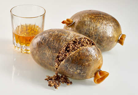 Sliced open cooked Scottish haggis with a tumbler of whisky, a traditional meal for Robert Burns Supperの写真素材