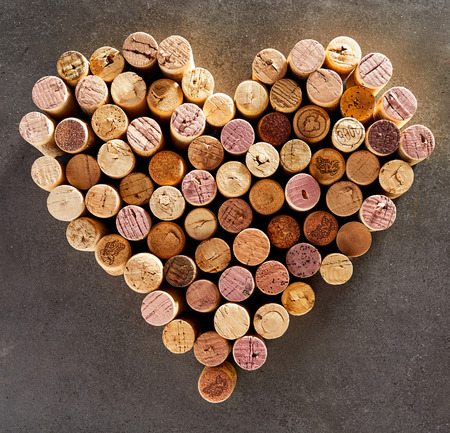 Wine corks arranged into shape of heart against dark backgroundの写真素材