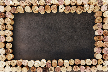 Wine corks arranged in rectangular frame against dark backgroundの写真素材