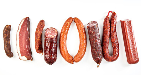 Delicious selection of spicy dried sausages with a portion of bacon or kassler arranged as a flat...