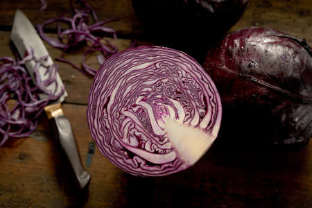 Composition of bowls with fresh assorted vegetables and cooked salmon and shrimps placed on yellow background between bowl with raw beef and liver stew with riceの写真素材