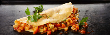 From above of nutritious vegetarian omelet with mushrooms and fresh vegetable salad served on white...