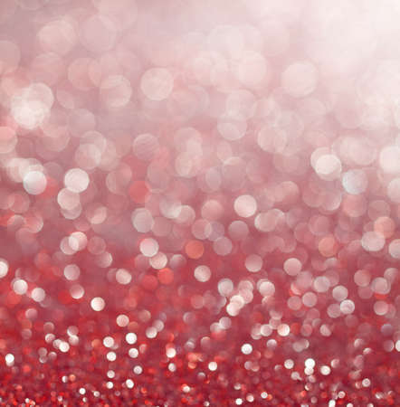 Festive shiny abstract blurred bokeh background with shimmering pink and red colored light spots for celebration concept decorative designsの写真素材