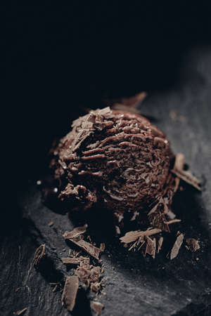 From above of yummy ice cream ball with smooth texture between grated chocolate on blurred backgroundの写真素材