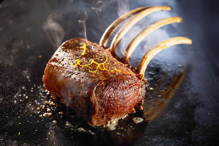 High angle of palatable venison rack cooking in oil on hot surface in restaurant kitchenの写真素材