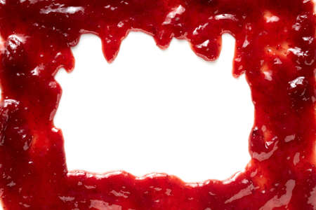Colorful red frame of fresh berry jam with drips from the top border into blank white copyspace in the center for use as a design template for advertising or textの写真素材
