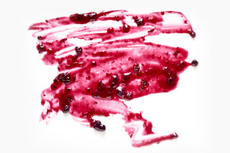 From above of sweet purple blackcurrant jam smeared on white background in studioの写真素材