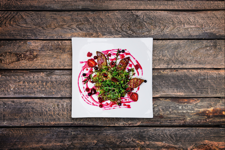 Foie gras salad with wild berry sauce.の写真素材