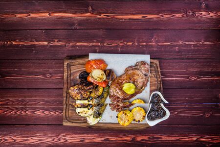 Delicious grilled steak with assorted roast vegetables and corn with sauce. Top viewの写真素材
