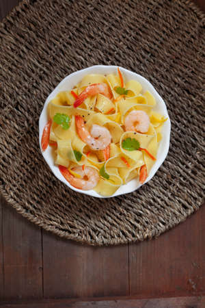 Pasta with shrimp and parsley, top viewの写真素材
