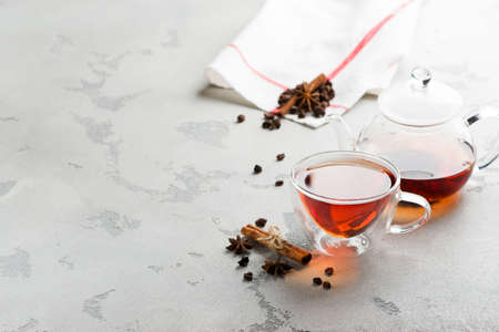 tea in a transparent mug and teapot, dried raspberries, cinnamon and star aniseの写真素材