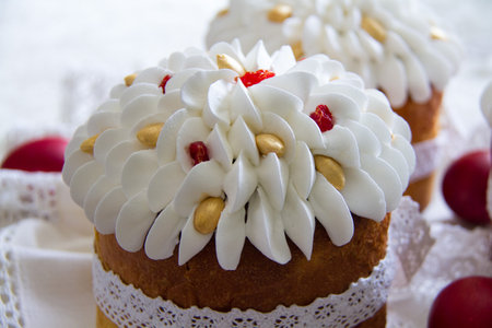 Beautiful Easter cakes decorated with white cream, almonds on top and tied around with a white lace...