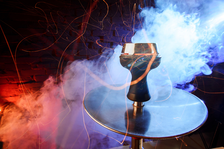 Shisha hookah with red hot coals. Sparks from breathe.