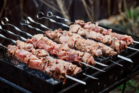 Juicy grilled kebab on grill in nature close-up. spaceの写真素材