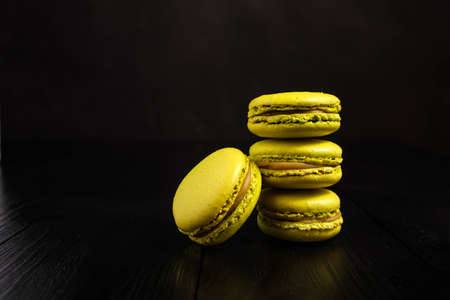 Pistachio-flavored macarons on a dark backgroundの写真素材