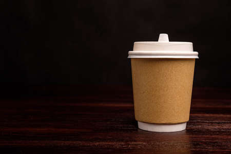 Paper cup for coffee on a dark backgroundの写真素材