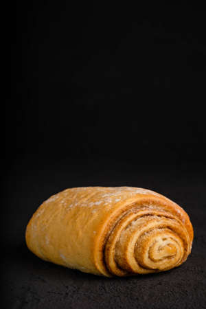 Cinnamon roll on dark backgroundの写真素材