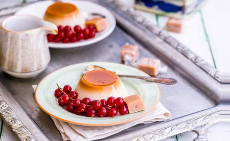 Creme Caramel with currant berry and caramel fudgeの写真素材