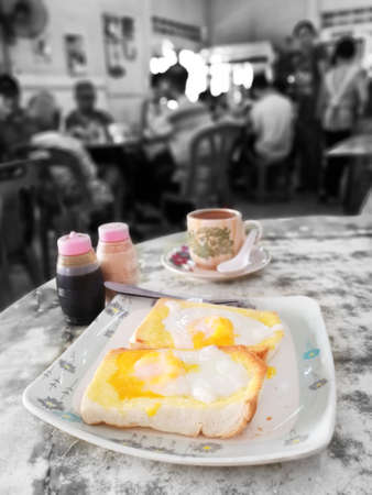 Toast With Half Boil Eggs On Top Plus White Coffee