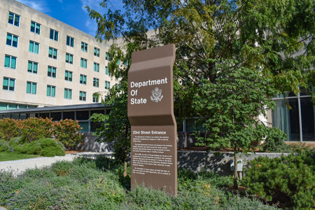 Washington, DC, USA - October 25, 2021: Brown U.S. Department of State Sign For the 23rd Street Entrance with the State Department Building in the Backgroundのeditorial素材