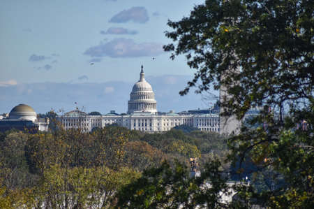 Washington, DC, USA - October 27, 2021: U.S. Capitol Building, Framed by Trees in the Foreground, as...