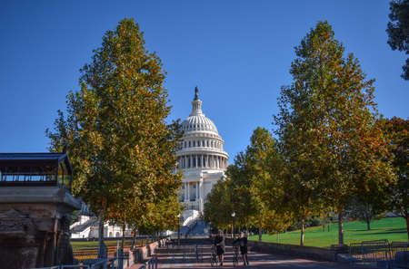 Washington, DC, USA - November 1, 2021: U.S. Capitol Building Viewed from the Southwest on a Bright, Clear Day in Autumn Surrounded by the Brilliant Colors of the Changing Leavesのeditorial素材