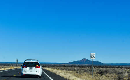 Williams, Arizona, USA - November 22, 2021: Desert scenery along the highway from Williams, Arizona to the Grand Canyon with bushes and brush in the foreground and mountains in the backgroundのeditorial素材