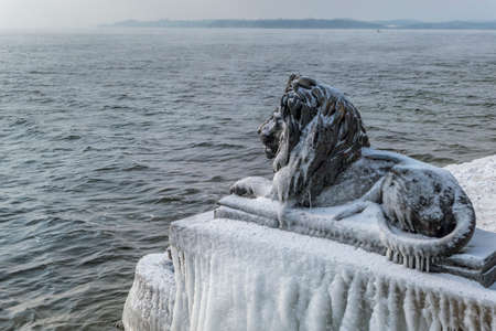 Ice-covered Bavarian Lion on a frosty winter day in Tutzing on Lake Starnberg, Upper Bavaria, Bavaria, Germanyの写真素材